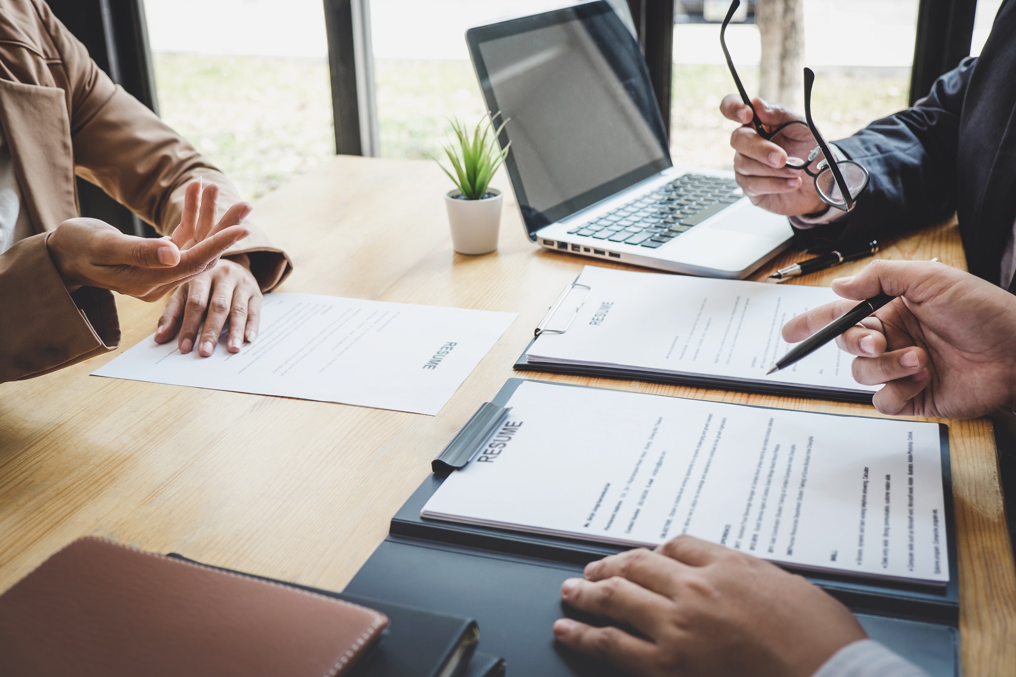 Two selection committee manager reading a resume during a job interview